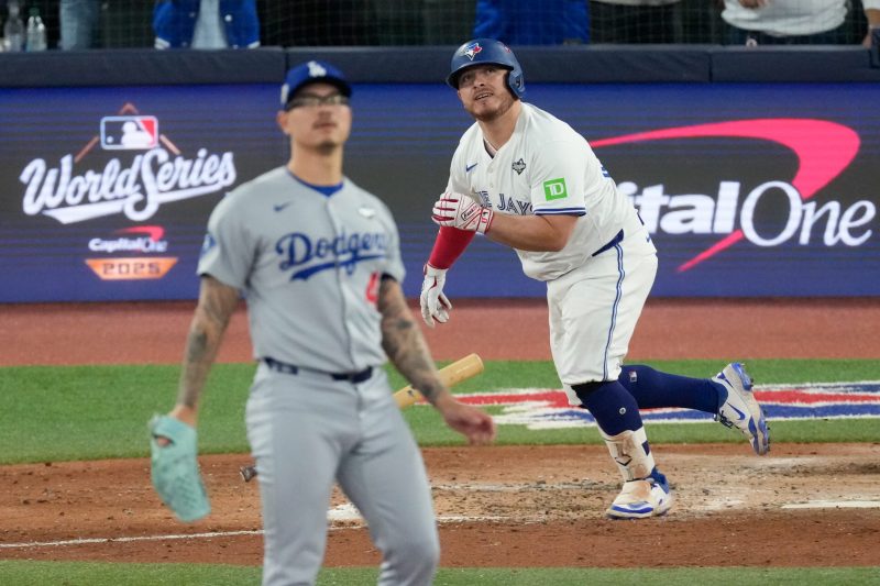 TORONTO – When it began, Blake Snell was still in control, not just of the game but an entire postseason. Addison Barger was on the bench, a virtual unknown beyond the Canadian border and his hometown of Tampa.
The Los Angeles Dodgers still had the whiff of indomitable defending champions, locked in a tie but possessing three MVPs who could change that at any time.
And then the sixth inning of Game 1 of this World Series began. And the baseball world found out exactly what the Toronto Blue Jays are all about.
A dozen batters came to the plate. Nine crossed it. Everyone put the ball in play or got on base. Three reserves were summoned off the bench and did exactly what was needed. And a rookie, a guy who began the season in the minor leagues but has produced two spine-tingling swings this October, made grand slam history.
The highlight reels will forever memorialize Barger’s 413-foot grand slam, the first pinch-hit slam in World Series history that pushed the Blue Jays’ lead to seven runs in an eventual 11-4 slaughter of the Dodgers that got the attention of anyone thinking this might be an L.A. walkover.
Can one half-inning define a season?
An organizational ethos? Capture the overwhelming belief among the dozens of players in that clubhouse and the relatively anonymous manager moving them on and off the field, like a game of Risk but with bats and balls?
It certainly can when virtually every Blue Jay was pulled from the shadows and shoved into the white-hot spotlight of Rogers Centre, 44,353 locals on tilt and a global TV audience expected to pull in massive viewership from Canada to Japan to the USA.
See, these Blue Jays are powerful in the aggregate, a crusher’s collective, a modern paradox in that they have light-tower powerful sluggers but also monk-like discipline when it comes to controlling the strike zone.
And in Game 1, they overwhelmed the defending champions.
“It’s the definition of our team,” says pitcher Chris Bassitt, who pitched a scoreless eighth inning in Game 1. “We have one through nine that are not fun to face. It’s been like that for a long, long time.
“Snell is a Cy Young pitcher. He has elite stuff. I’m proud of the guys who came off the bench to wear him down.”
Truth be told, that was a collective effort from the 12 Blue Jays who grabbed a bat at some point during Game 1.
They loaded the bases in the first inning and did not score – but coaxed 29 pitches out of Snell, who looked unbothered and unbeatable in posting a 0.86 ERA through three starts to push the Dodgers to the pennant.
“I think that’s what our identity is,” says All-Star infielder Bo Bichette, who returned from a knee sprain to play his first game since Sept. 6, and first at second base since a minor league appearance in 2019.
“Whether we’re putting up runs or not, we’re going to make them work. He’s an unbelievable pitcher and a tough task, for sure. But that was our goal going in.”
And then, the dam withered, and finally broke.
The first crack came when Daulton Varsho tied the score with a first-pitch, two-run rocket off Snell in the bottom of the fourth, the first left-handed hitter to take Snell deep since 2024.
Two innings later, Bichette drew a leadoff walk. And like a basketball coach digging deep into his rotation, Schneider went liberally to his bench.
And history followed.
Bichette, still gimpy on his left knee, exited for pinch runner Isiah Kiner-Falefa, who’d take over at second base. Alejandro Kirk, their 5-foot-8, 245-pound anchor behind the plate, followed with a rocket just below the 328 mark on the right-field wall.
Varsho was next. Snell locked in, jumping ahead in the count until Varsho sneered at a 2-2 slider in the dirt, then fouled off a slider and a curveball before Snell finally cracked, drilling Varsho in the shoulder.
It was his 100th pitch, and it was the second of three Blue Jays plate appearances in which they forced the Dodgers to throw nine pitches – all resulting in Blue Jays reaching base.
Snell was done, failing to record an out in the sixth. Mission accomplished.
“He threw (29) pitches in the first. It’s hard when you not punching guys out, it wears you down” says Bassitt. “No matter how good you are, it wears you down.
“The fact we don’t strike out a lot – it’s really hard to face our lineup.”
The bases were loaded. The party was on.
Dodgers reliever Emmet Sheehan yielded the go-ahead hit to Ernie Clement, his 20th knock this postseason against just two strikeouts. Schneider, ever the mad scientist, tossed his regular No. 2 hitter, Lukes, up to pinch-hit.
Lukes clearly wanted to fit in with his mates: He, too, produced a nine-pitch plate appearance, and a bases-loaded walk.  Now 4-2.
No. 9 hitter Andrés Giménez stroked an RBI single. Leadoff man George Springer offered the Dodgers a momentary reprieve, grounding into a force out at home.
Meanwhile, Barger loomed on the bench like a glow stick at dusk. Veteran Jays watchers of at least a week knew he was lurking, that Schneider would throw him at just the right time.
Schneider said postgame he wanted to force a lefty into the game. Barger was ready.
In the Blue Jays bullpen, so was Eric Lauer.
“He said, ‘he’s going to hit a home run here,’” says Bassitt. “We were just waiting for him to do it. And damn, he did it.”
Barger delivered, ripping a 413-foot drive into a bobbing throng of humanity in the right center-field seats. Oh, it was nearly an out-of-body experience for the fellows in the white jerseys, too.
“That was something else. That was something I’d never felt before my entire career,” says Bichette. “I felt like I left my body and was on the field with him.”
It was 9-2. All but one Blue Jays position player had touched the field, and eight tallied a run scored. Schneider had concocted a poisonous brew for the Dodgers.
“Every button he pressed tonight hit,” says Kiner-Falefa. “There’s so many different ways we’re able to put things together, but John Schneider does such a good job plugging us in at the right opportunity.
“I just feel like he does such a great job using and deploying everybody. You come to the field knowing you might not start. But you’re gonna play, maybe at a crucial moment.
“Our bench is very special.”
Did we mention that it was still not over?
Kiner-Falefa began the inning as a pinch runner. About a half hour later, he was the 10th batter to come to the plate, a two-fer in one inning he’d never experienced.
Two batters later, Kirk recorded his second hit of the inning – a towering two-run blast to left field. Blue Jays 11, Dodgers 2, and a star turn for Kirk – who had three hits and reached base four times – his teammates savored.
“Kirk’s at-bats, the whole year, are insane,” says outfielder Myles Straw, who started against Snell in an effort to load right-handers against the southpaw. “He’s one of my top three favorite players of all time. Just his swag, his demeanor, he’s so chill. It’s like he’s playing in a spring training game out there. It’s insane.
“He’s unbelievable. The contact skills, the ability to hit the ball hard – whenever you got a guy at third, less than one out, 98% of the time I’d say the run will score.”
Kirk had 127 hits and 15 home runs this season – and struck out 15 times. Only the punchless Kansas City Royals struck out less than the Blue Jays, a potent combo of power and precision.
By night’s end, the spotlight was stolen. And perhaps a trove of casual viewers were put on to what these Blue Jays are all about.
“I think they should know already,” says Kirk through an interpreter. “The type of team that we are. The way we play.
“And that’s the reason why we’re here.”
This post appeared first on USA TODAY